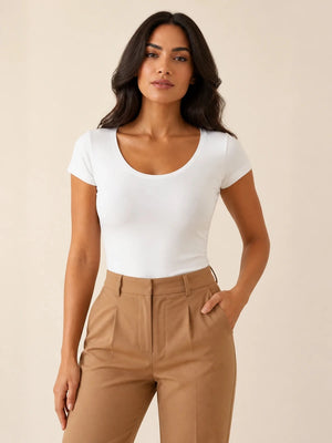 White scoop-neck cap-sleeve top tucked into camel trousers, front view