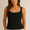 Model wearing the ELLY black chevron ribbed knit top with a structured square neckline.