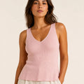 Model wearing the ELLY blush pink ribbed knit V-neck top with a fitted sleeveless silhouette.