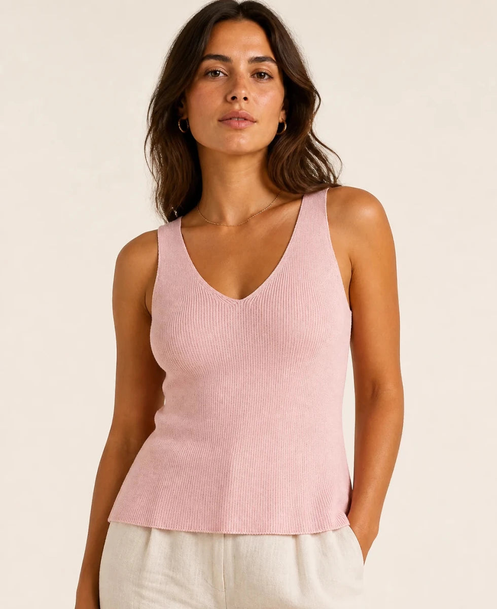 Model wearing the ELLY blush pink ribbed knit V-neck top with a fitted sleeveless silhouette.