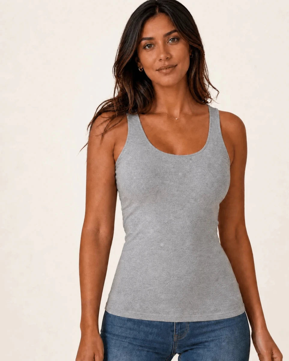 Grey longline tank top worn with blue jeans, front view