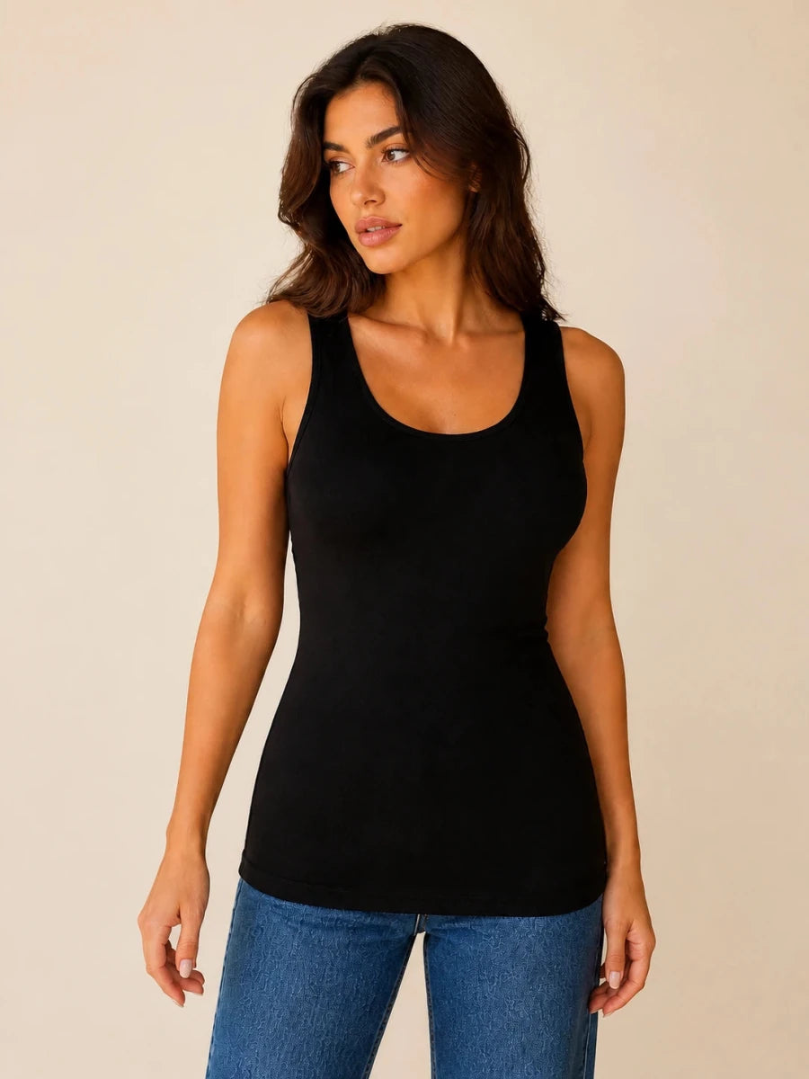 Black longline tank top worn untucked with blue jeans, front view