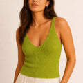 Model wearing the ELLY lime green ribbed knit V-neck top with a fitted sleeveless silhouette.