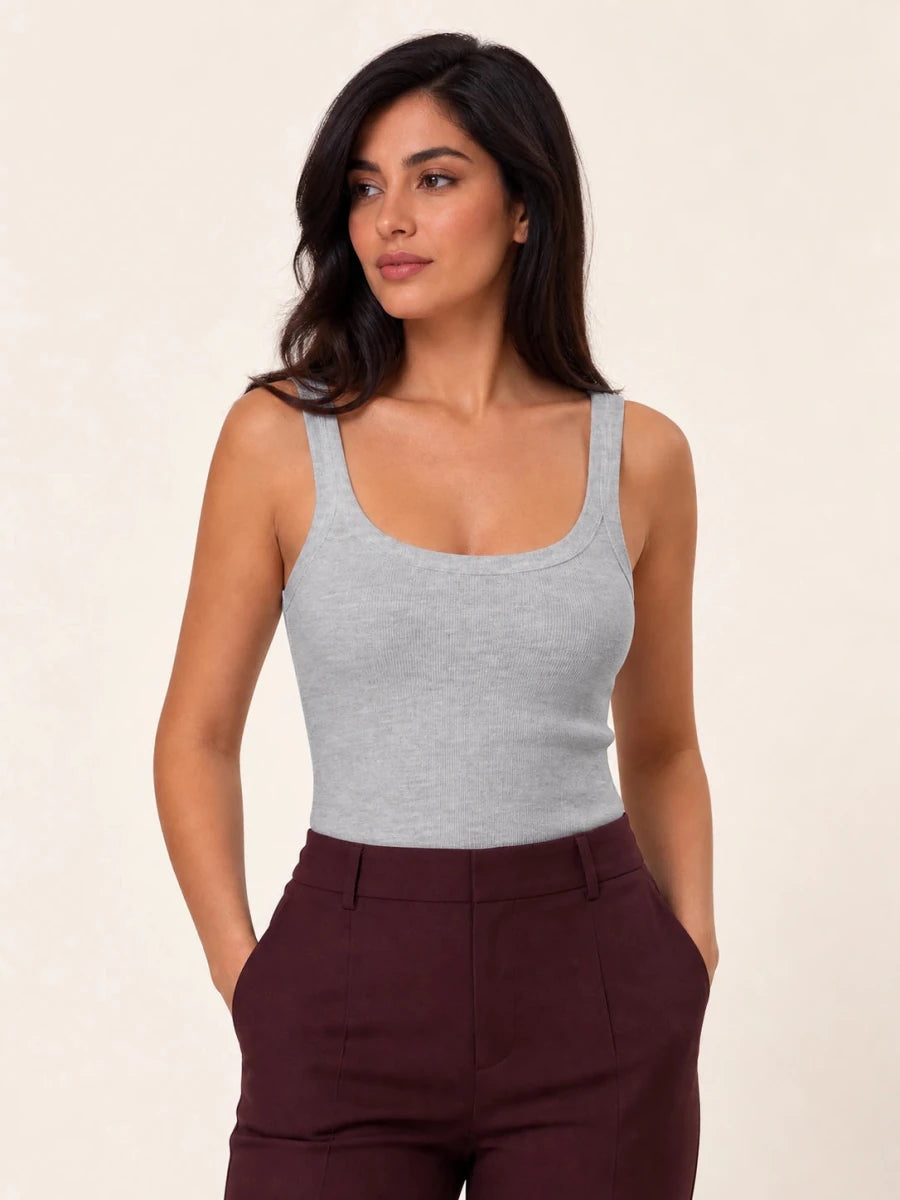 Grey ribbed tank top tucked into burgundy trousers, three-quarter front view