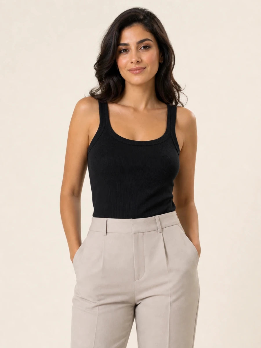 Black ribbed tank top tucked into light stone trousers, front view