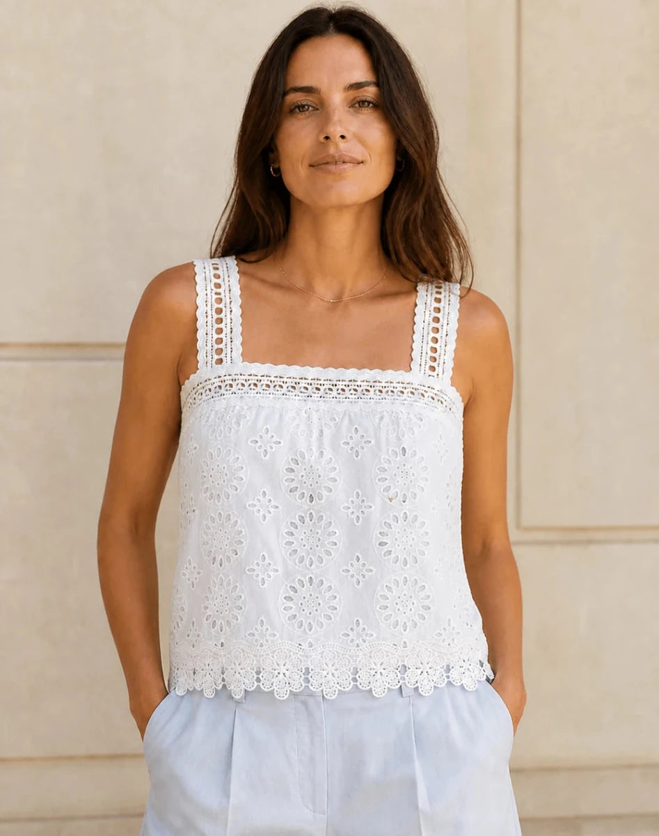 Model wearing the ELLY white floral eyelet lace camisole top with square neckline and scalloped hem.